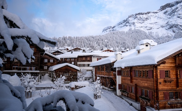 Snow-covered chalet nestled in a peaceful mountain setting